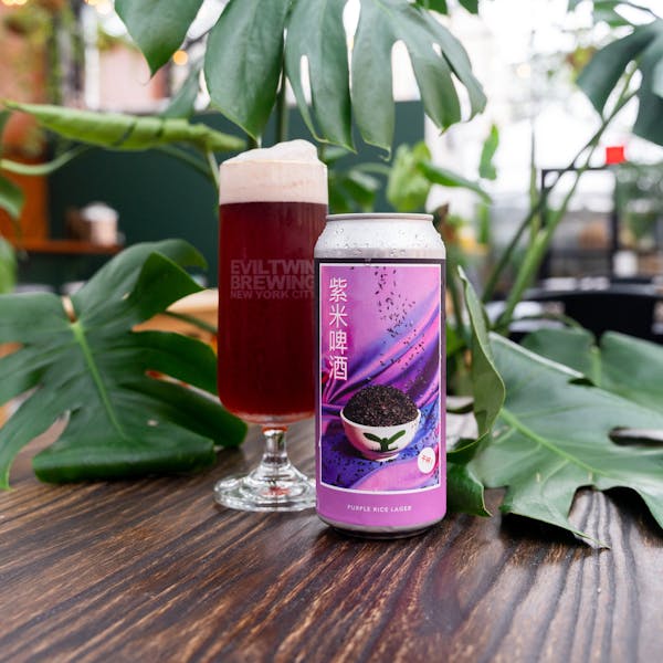 purple beer in glass on table