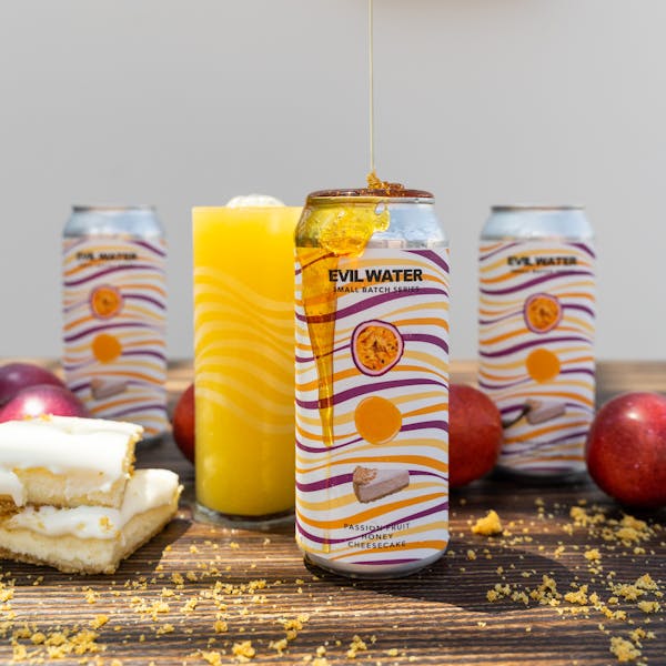 yellow seltzer in glass on table with honey and fruit