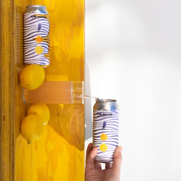 seltzer pouring on yellow shelf with lemons