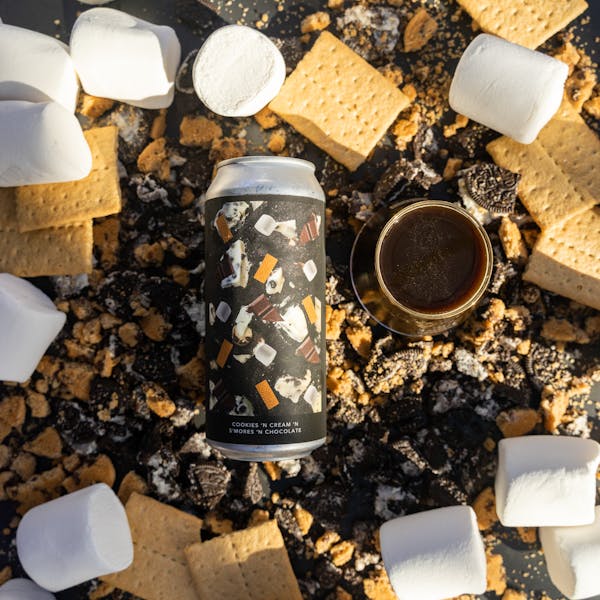 dark beer in glass with s'mores ingredients