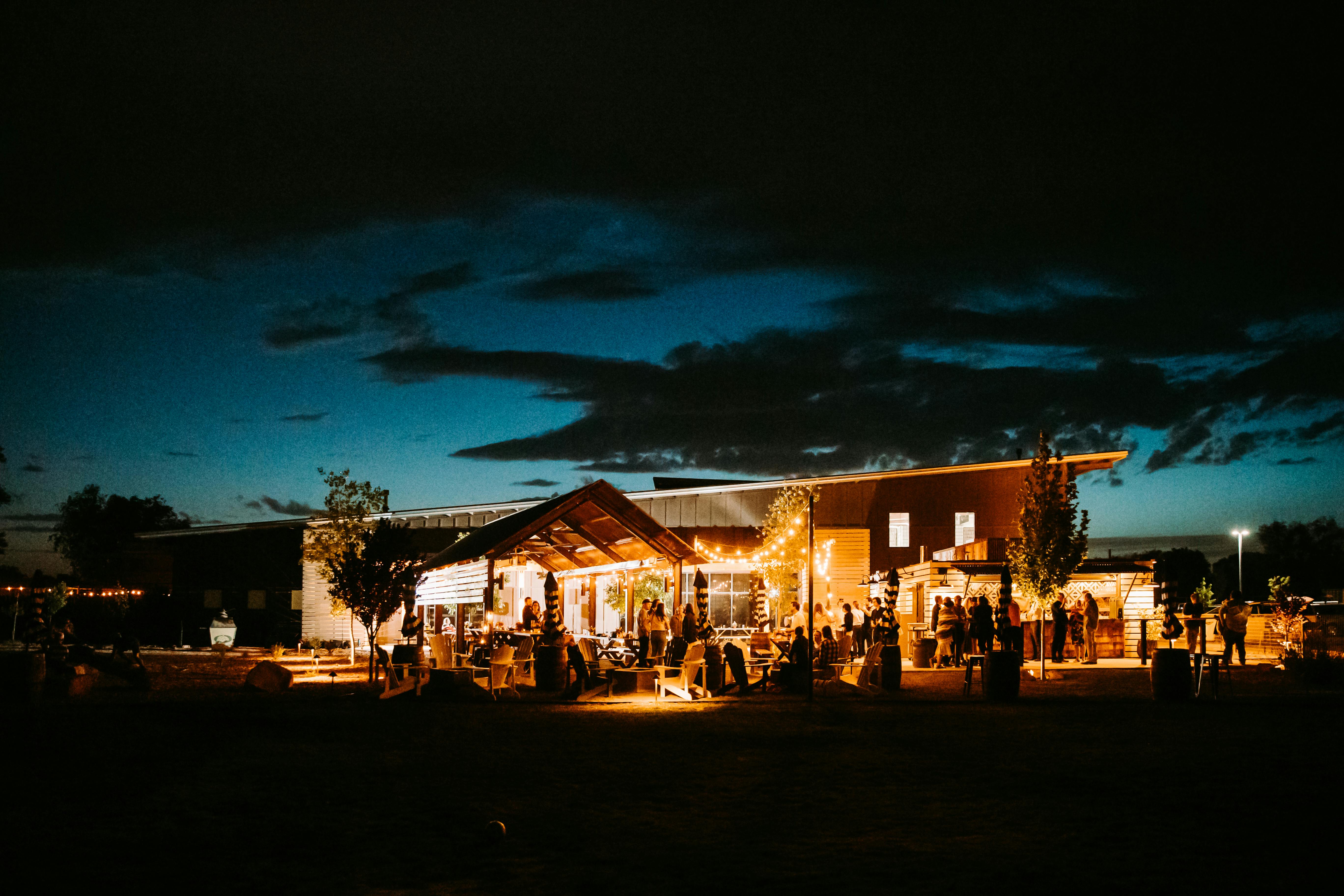 nightime exterior photo of the Corral at Ex Novo Brewing