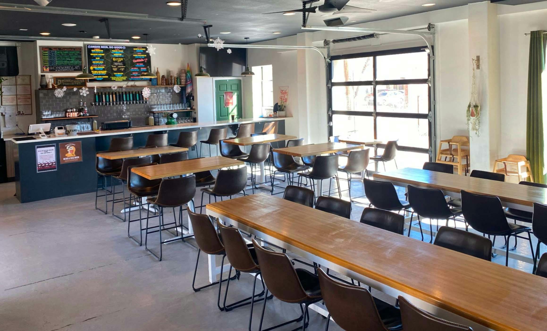 taproom interior photo with long tables and big windows