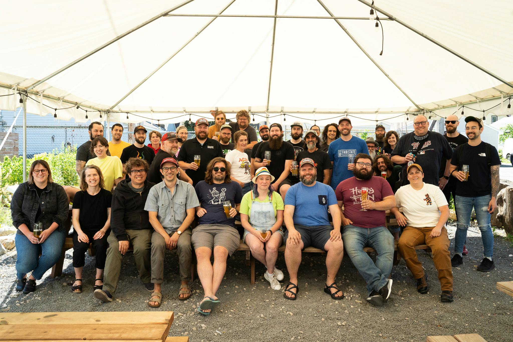 Photo of our full staff outside under a tent in the beer garden.