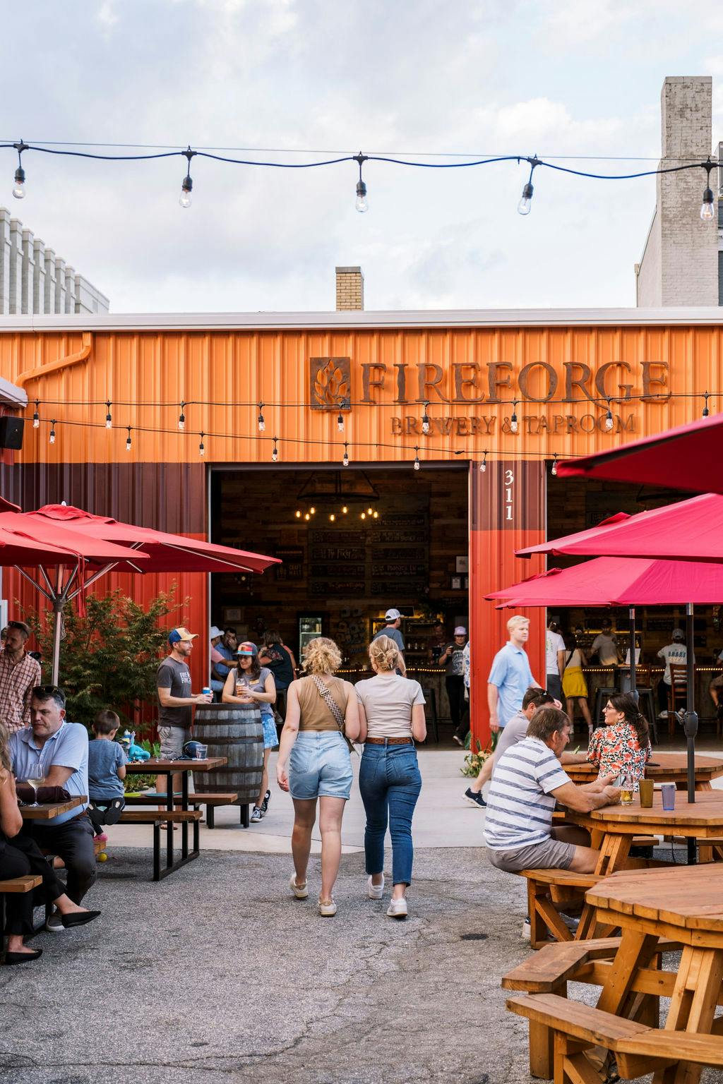 230929_Fireforge-1334 guests enjoy beers at a table outside on the Fireforge taproom patio