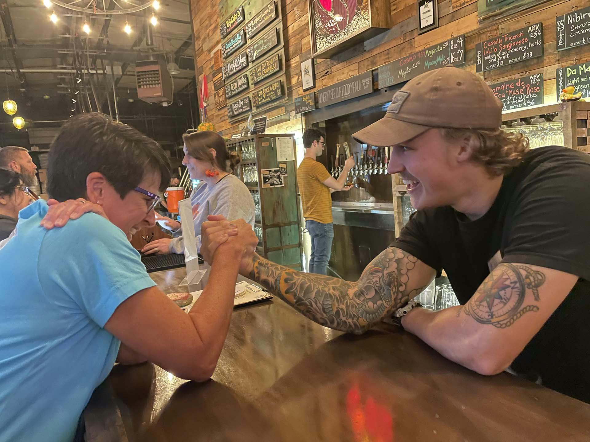 IMG_4765-web Two people arm wrestle over a bar