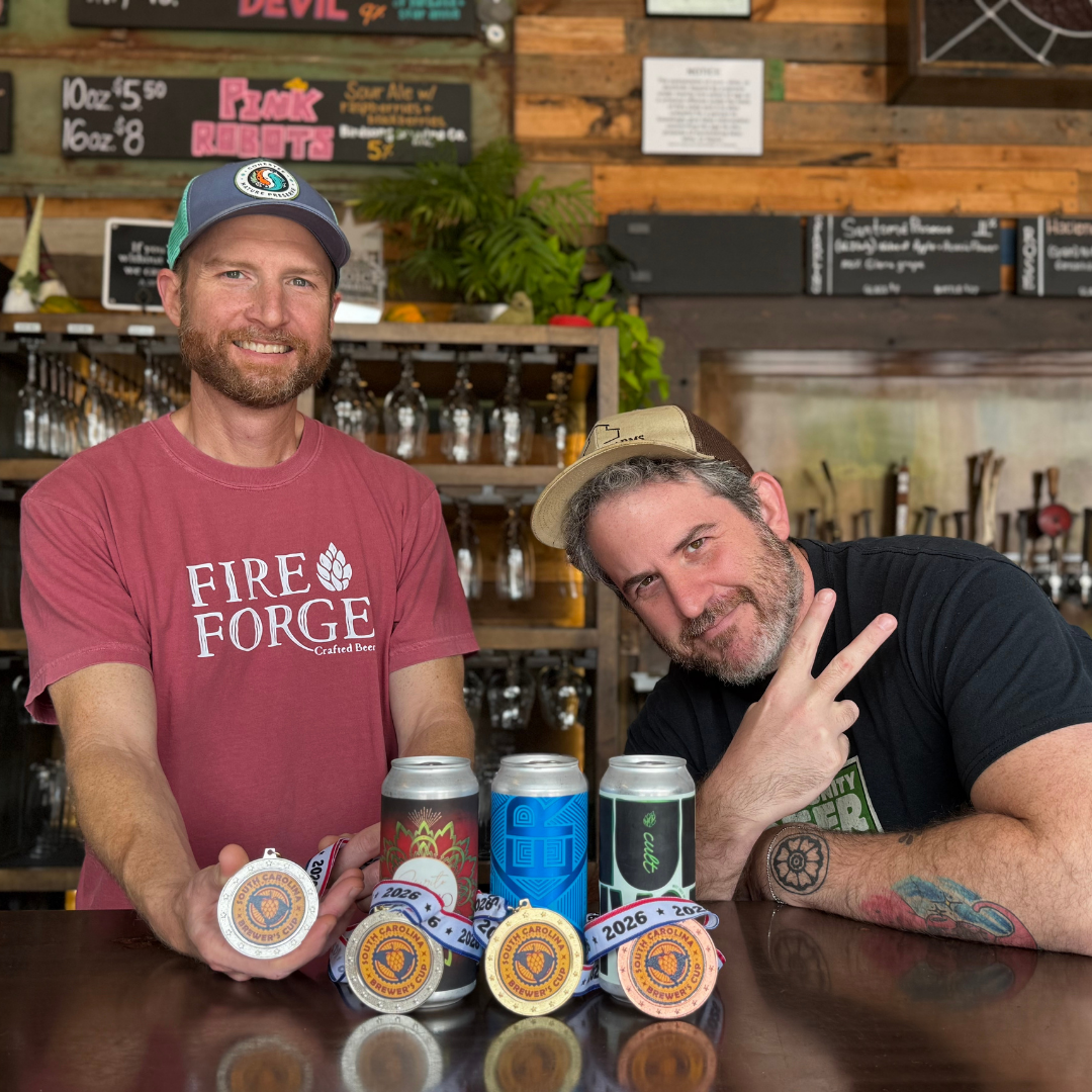 Fireforge Co-Owner & Head Brewer Brian Cendrowski and team member Justin Sharan gather with the award winning beers and medals in Fireforge's taproom.