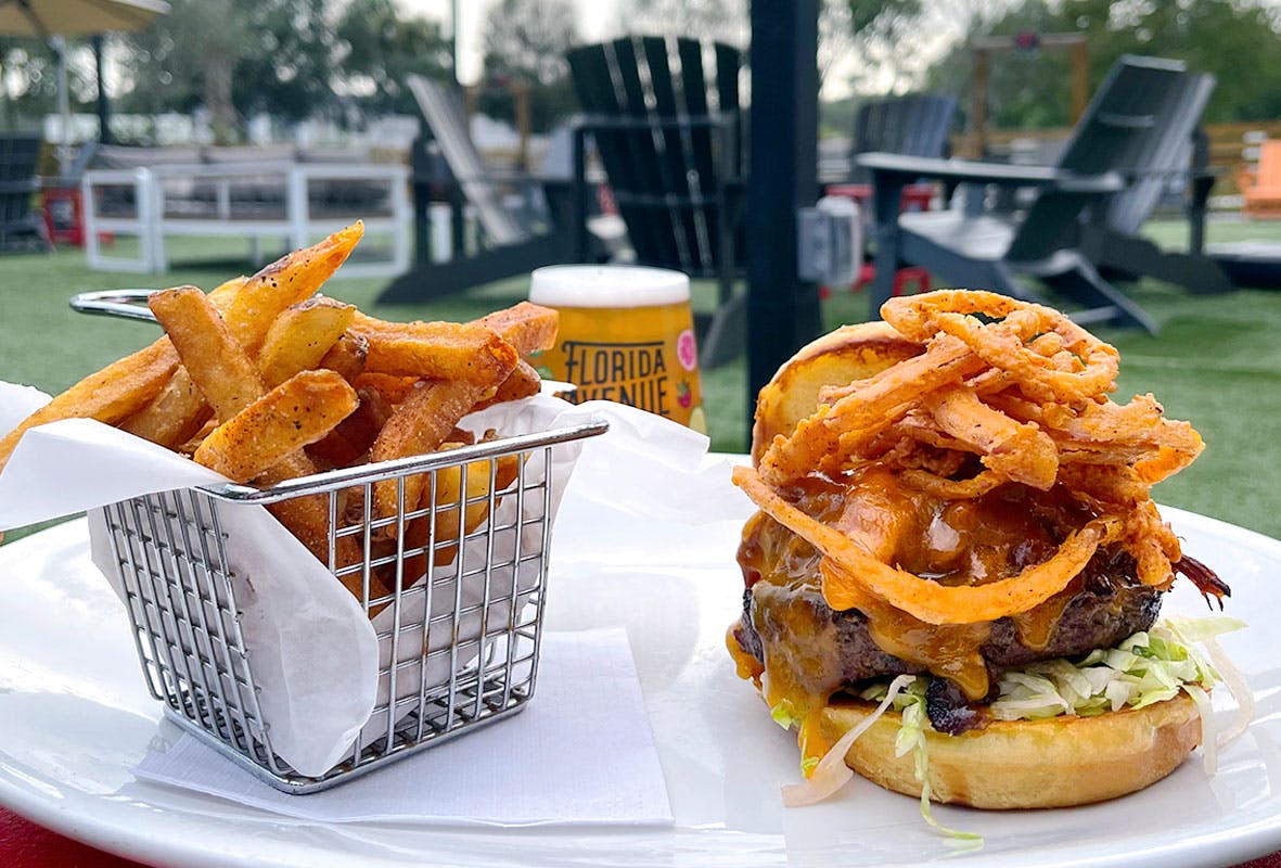 ½ lb. grilled all beef patty, topped with brown sugar BBQ braised chicken, lettuce, cheddar cheese, Nashville fried onion straws on a toasted potato bun