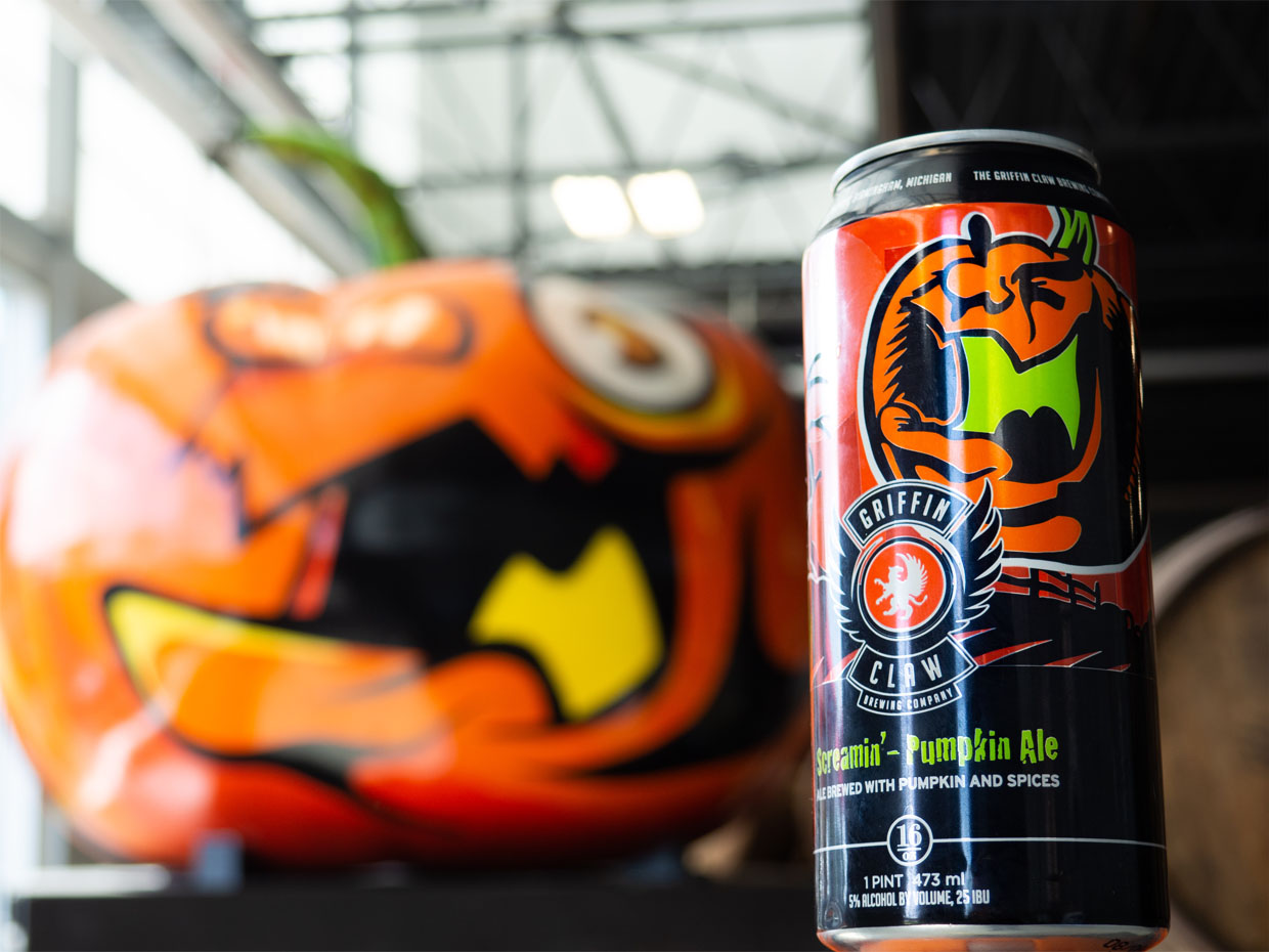 Screamin Pumpkin Ale Can in front of Pumpkin