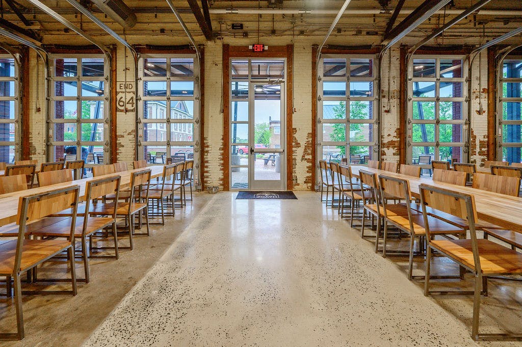 DSC_2157 Havoc Brewing Interior taproom space -long wooden tables with wooden chairs, exposed brick walls and large garage doors that open onto the patio
