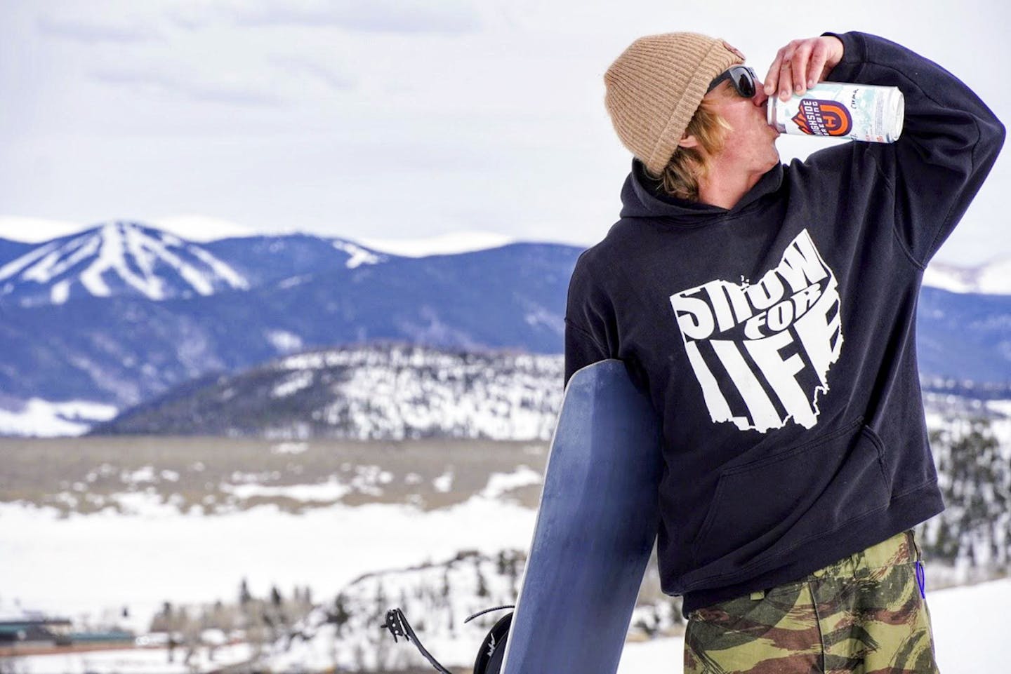 Snowboarder drinking beer