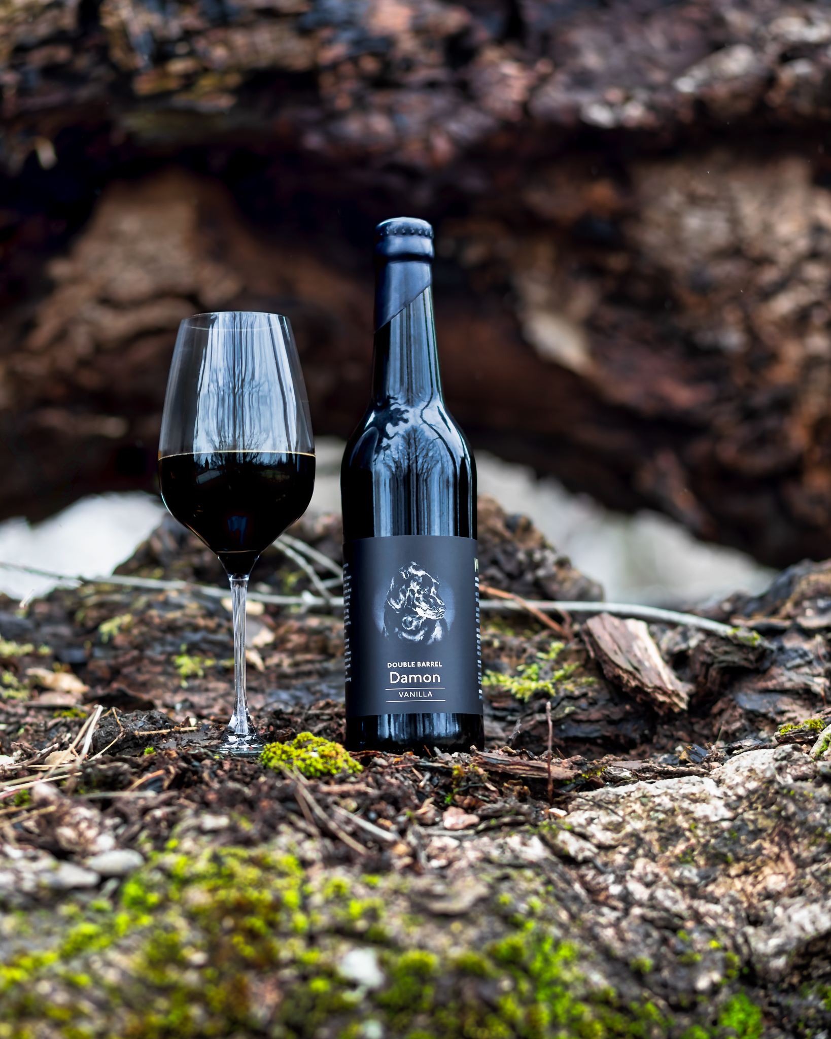 Bottle and glass in moss