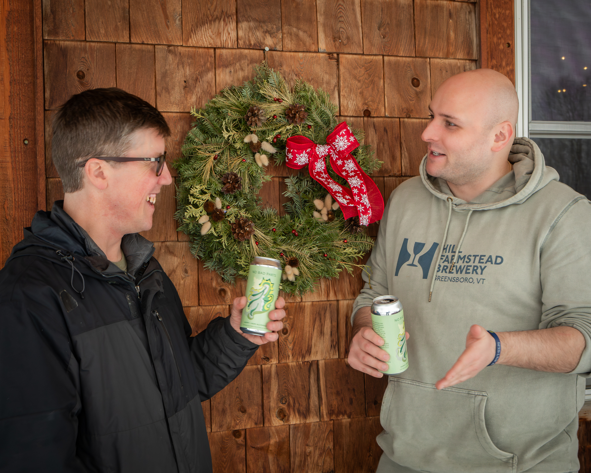 Two men drinking cans
