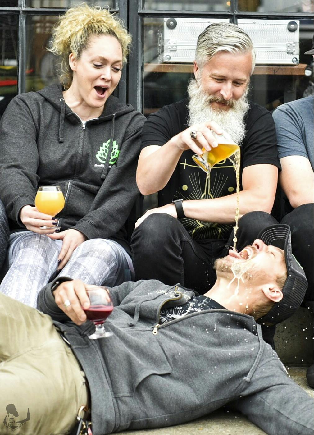 Lindsey & Tony pouring a beer on zach