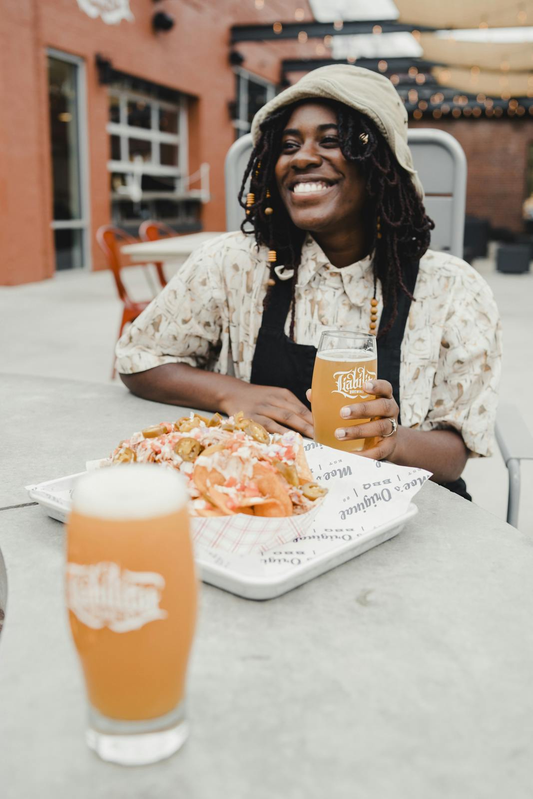 customers drinking a beer and eating nachos