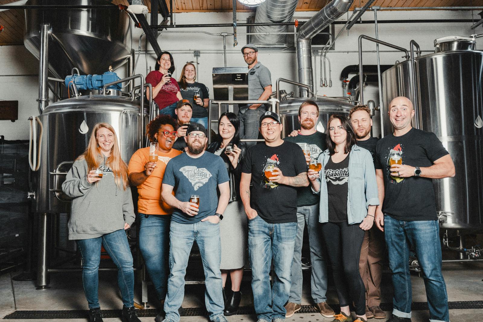 the staff in front of the brewing equipment