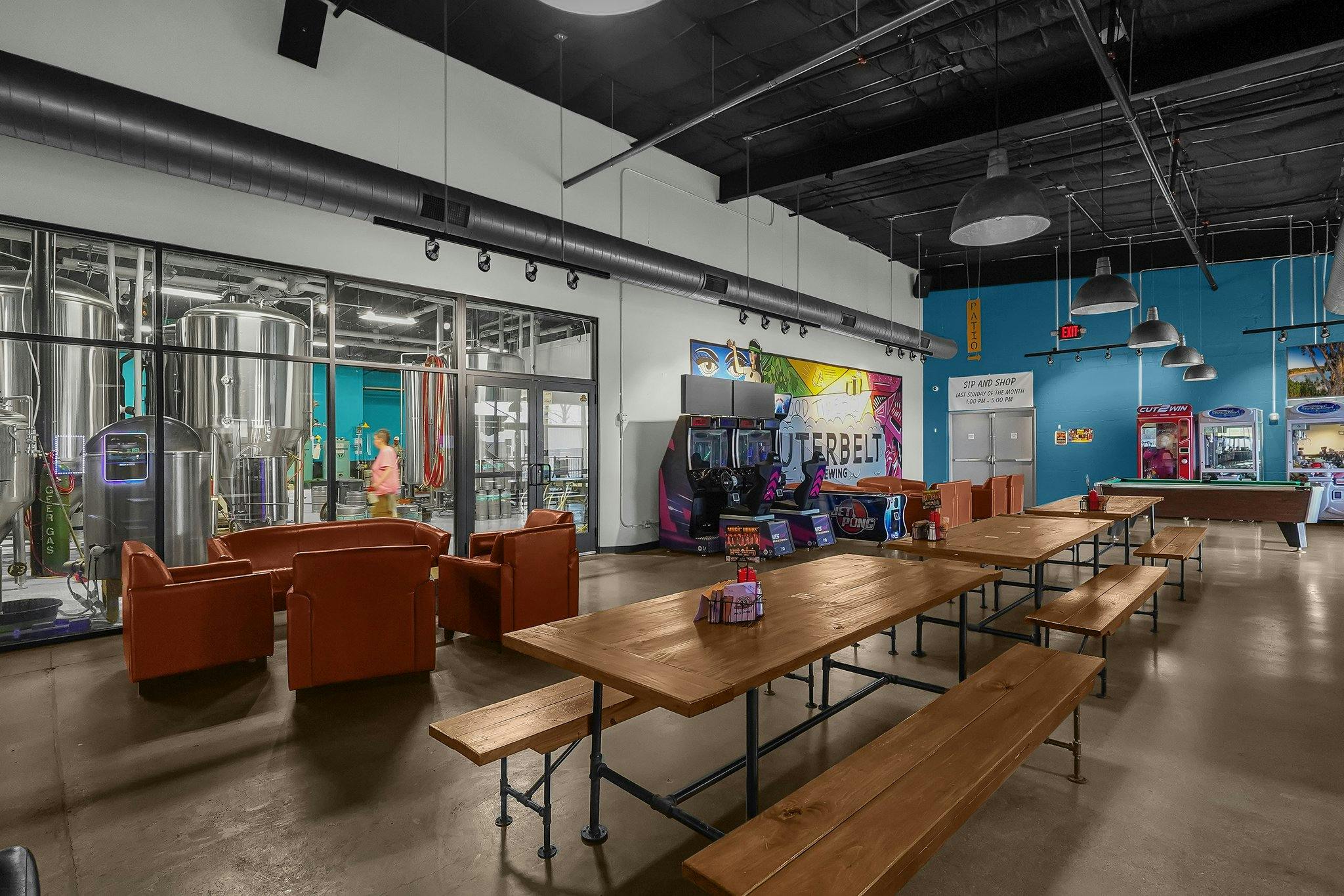 13-web-or-mls-3560-dolson-ct booths along a wall mural in the Outerbelt taproom