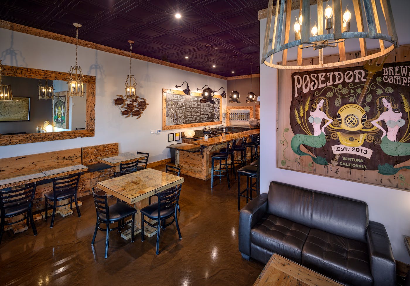 Poseidon-15-schafphoto-tasting room A small, well-lit taproom with patrons ordering beers at a bar