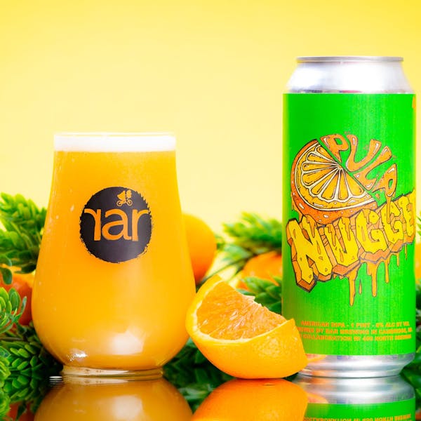 Glass of RaR beer with 16 oz. can with oranges