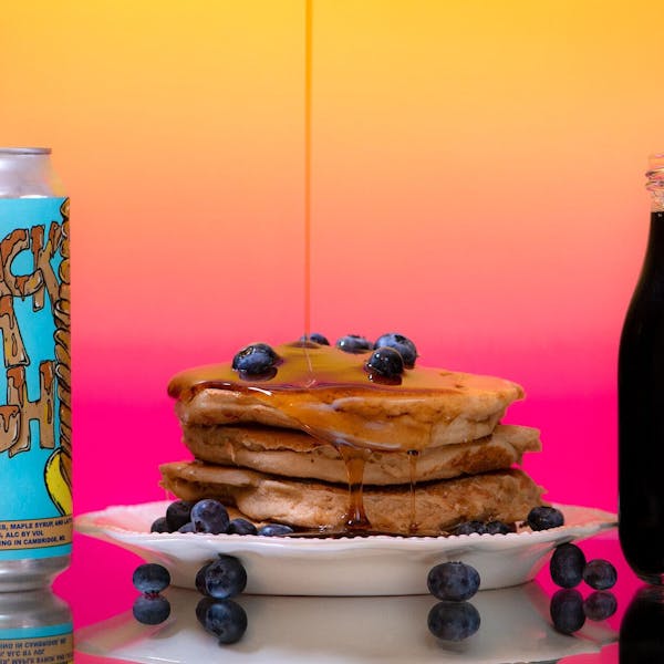 Glass of RaR beer with 16 oz. can with pancakes