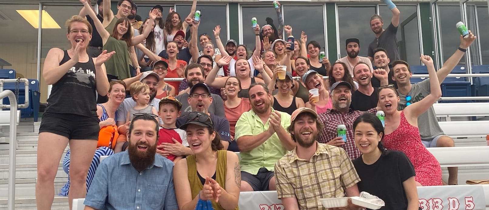 Rising Tide Team at Seadogs Game A majority of the Rising Tide staff and their significant others gathered together and cheering at a SeaDogs game.