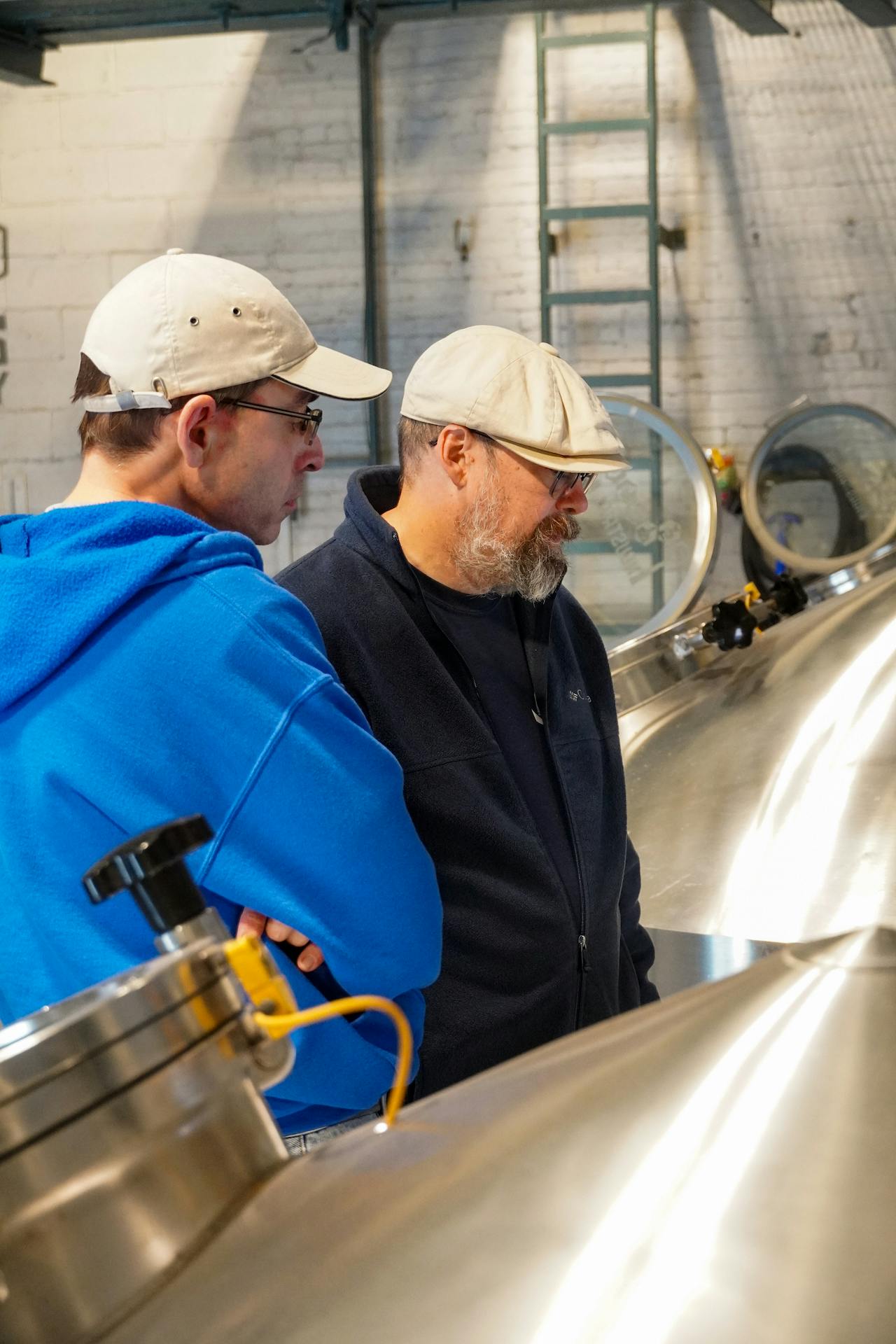 RJ-DrJayBrewing Javier and Ricardo looking at the brewing process.