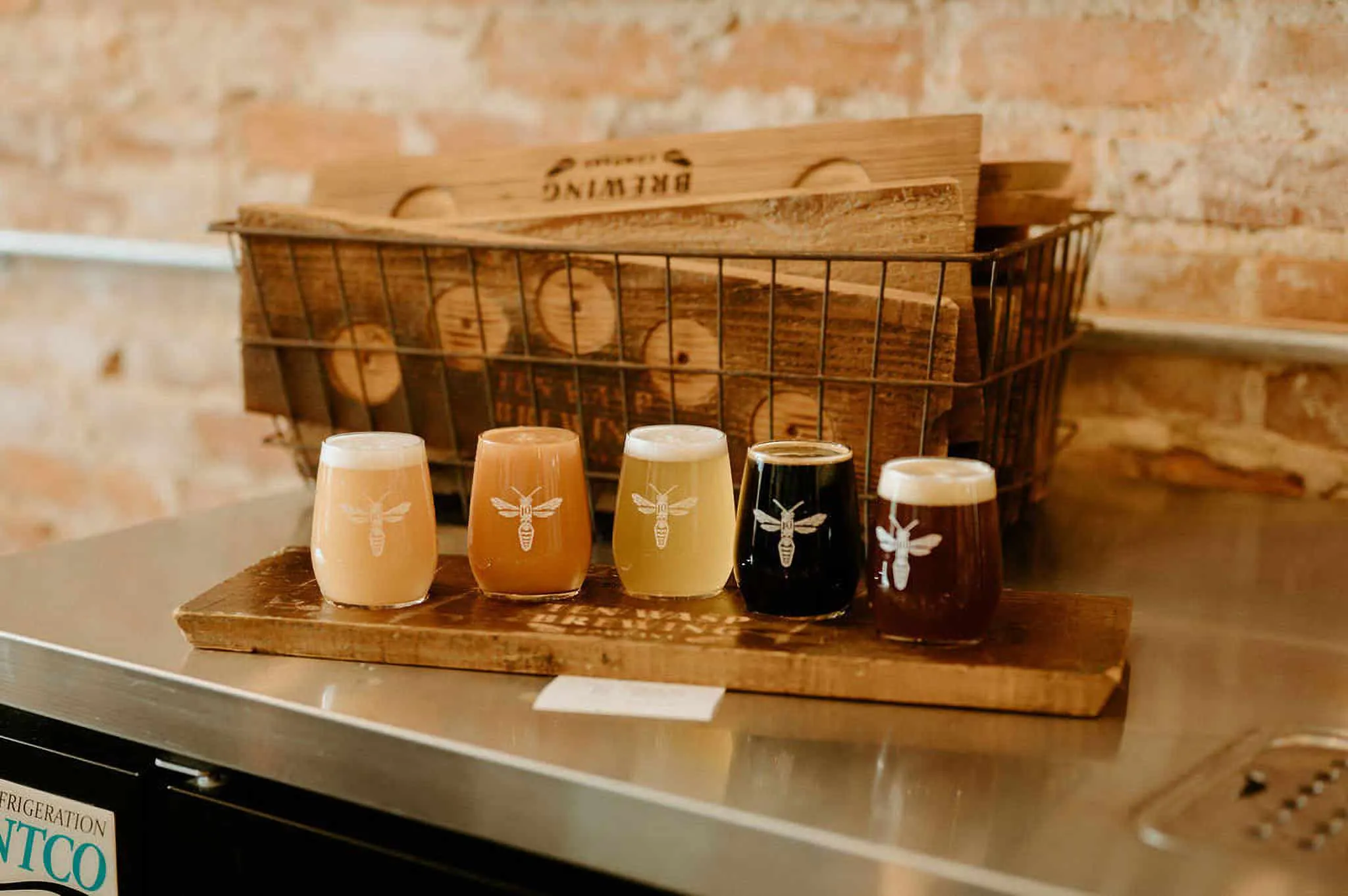 A flight of beer on a stainless steel bar