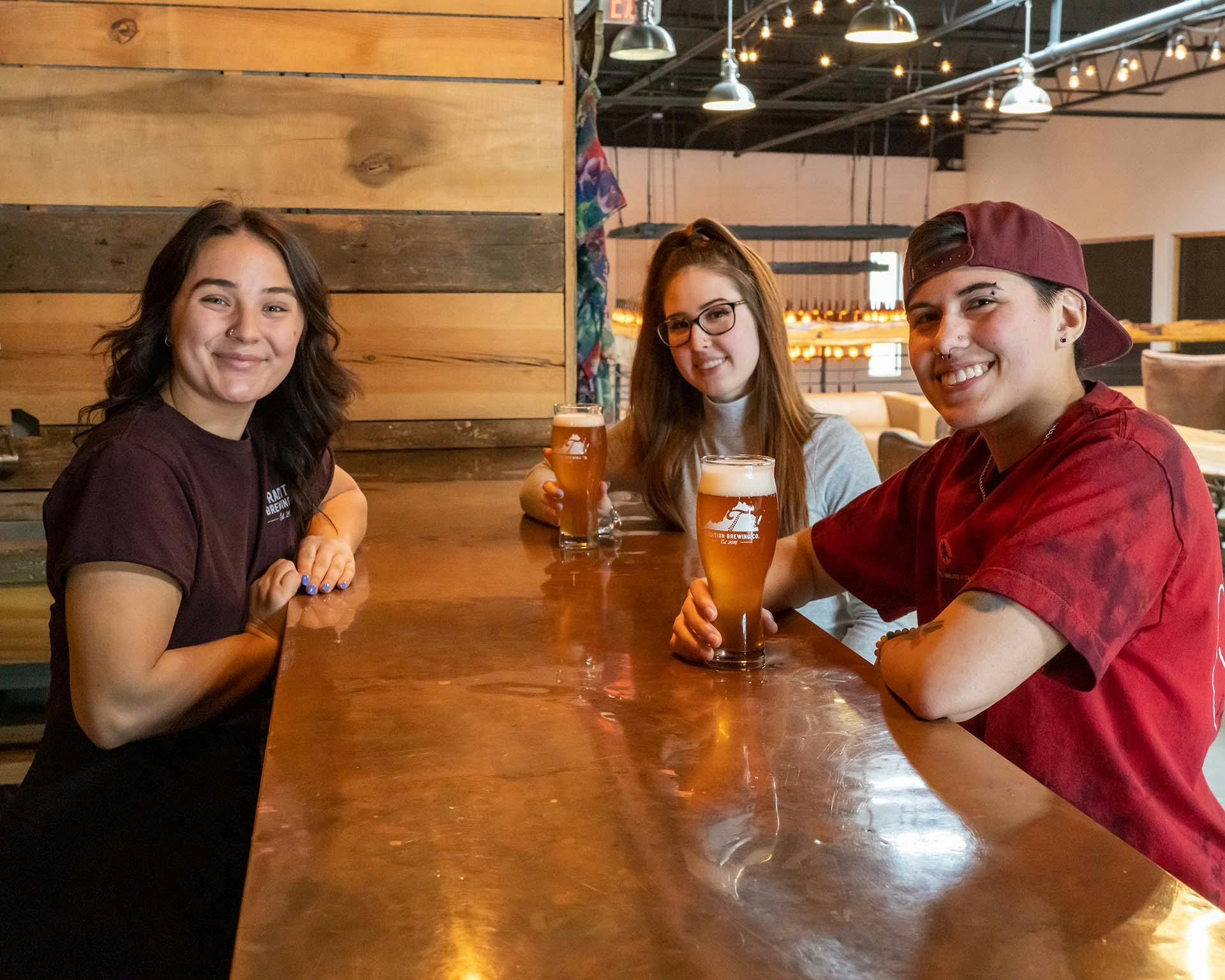 Traditional brewing taproom with people sitting around drinking beer 